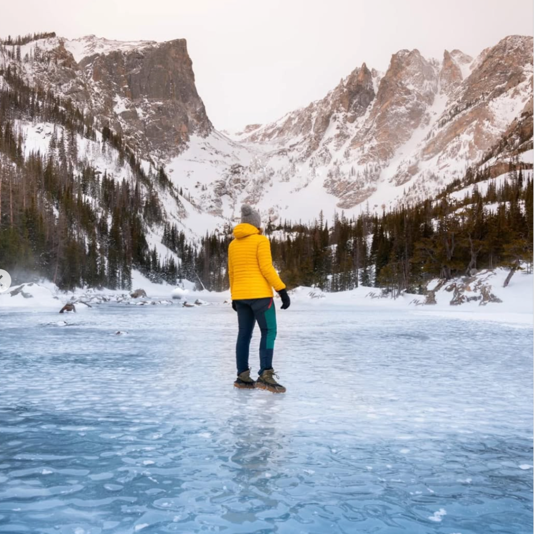 A person walking across a frozen lake