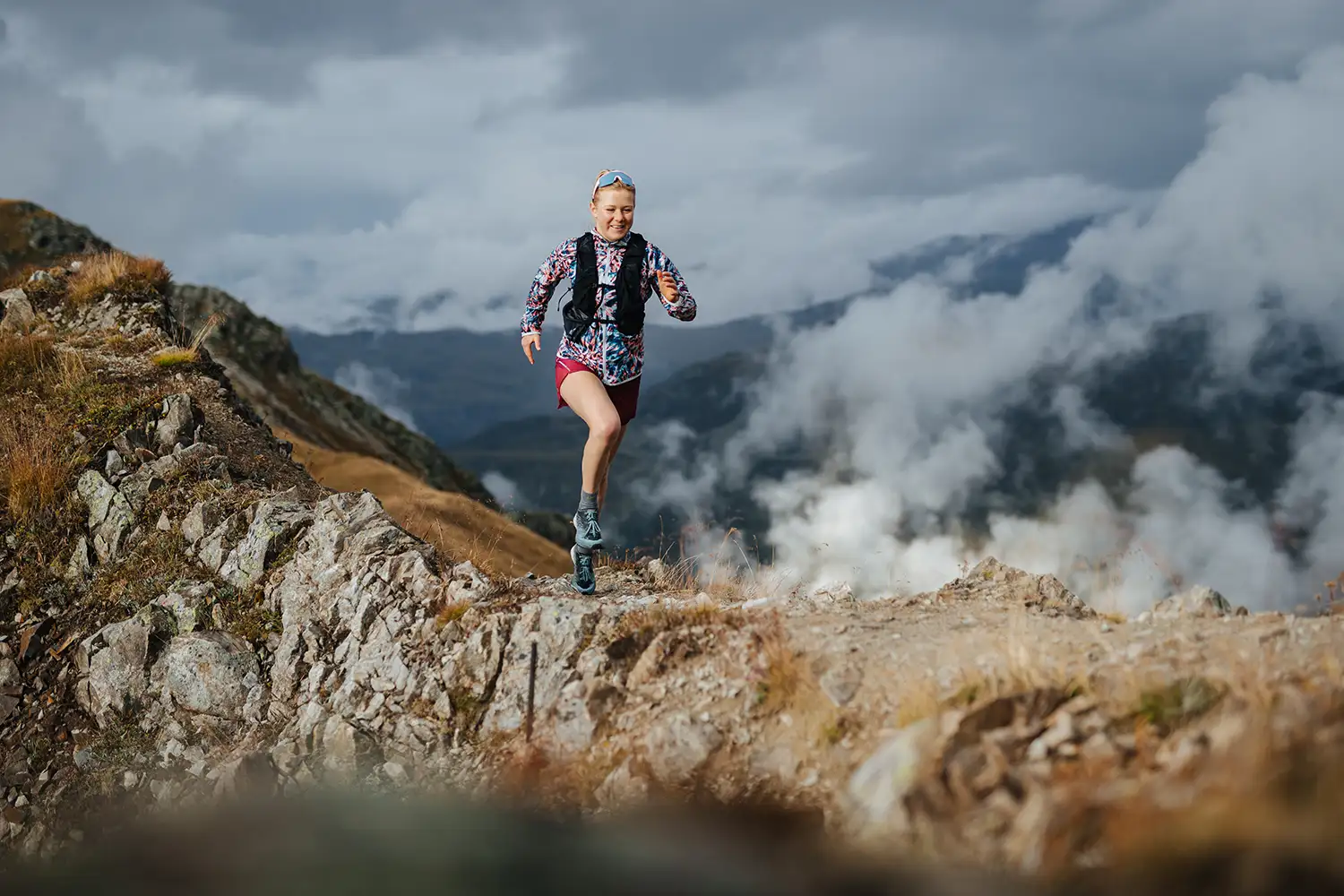 women running along mountaintop