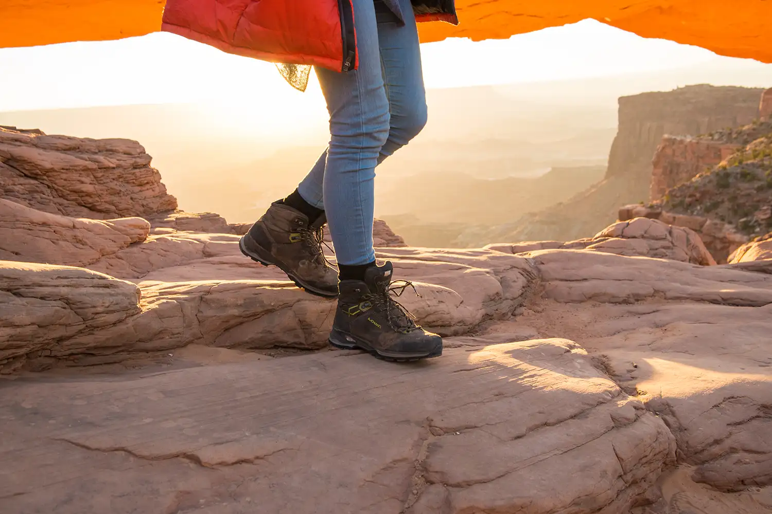 image of woman's hiking boots walking on desert rock