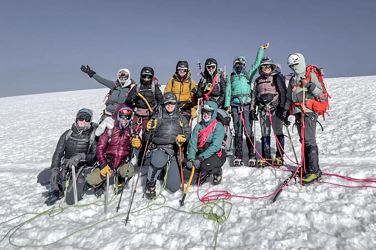A group of young woman mountaineers standing for a picture