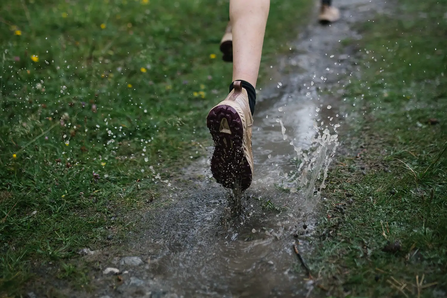 woman running on wet trail