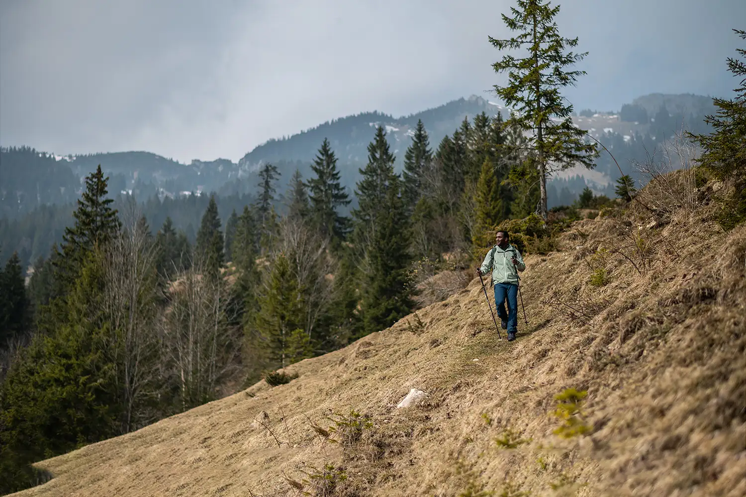 man hiking on hillside