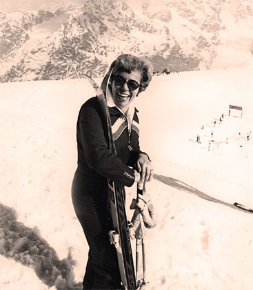 a person with skis on a snowy mountain