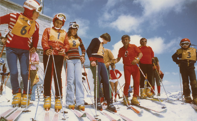 a group of skiers pose for a photo