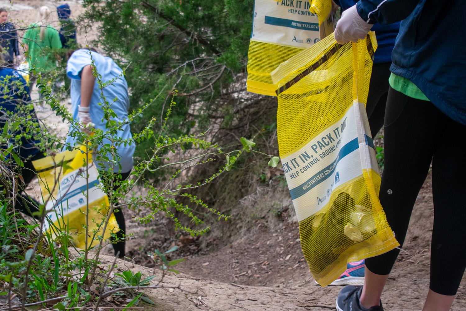 trail clean up with yellow trash bags